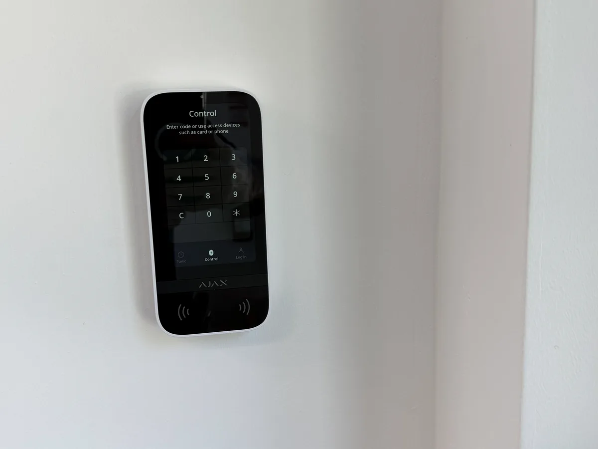 Ajax commercial alarm keypad installed by CastleOak in a business office